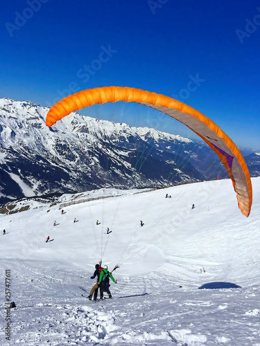 paraglider with instructor over the ski slopes