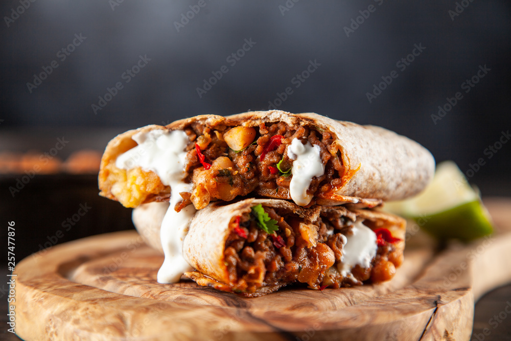 Mexican burrito with beef, beans and sour cream Mexican burrito with beef, beans and sour cream
