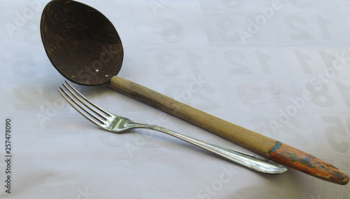 Concept photo - Comparison of two traditions, fork and spoon