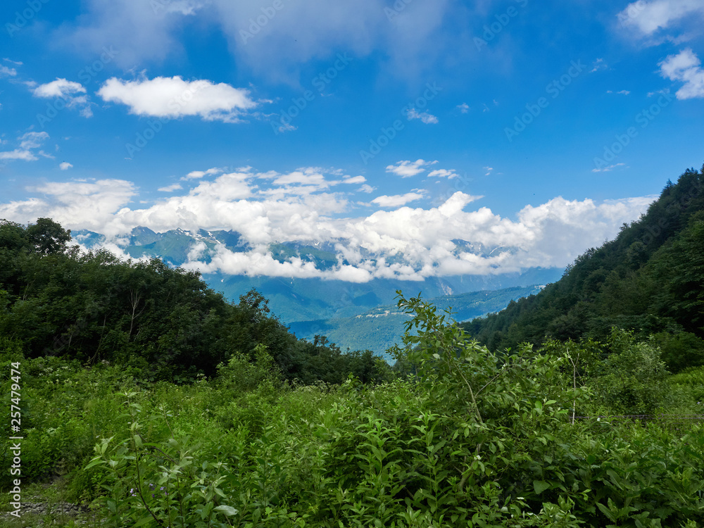 Green mountain slope with serpentine road that descends into the valley. Green mountain slope with serpentine road that descends into the valley.