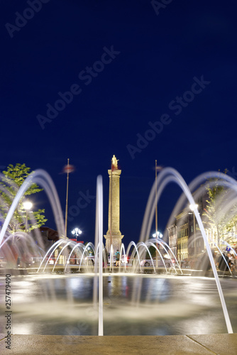 Water fountains on Place Vauquelin at night with Nelson's Column and Place Jacques Cartier behind in the Old Port district photo