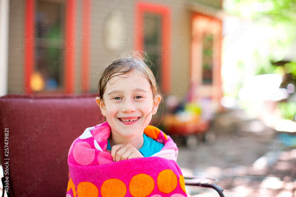 Girl smiles with wet hair and sits in armchair wrapped in towel Stock ...