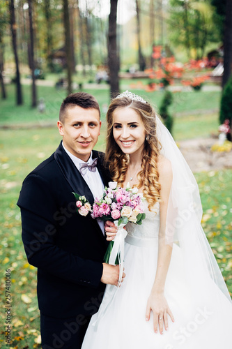 Great portrait of a wedding couple, which is walking in the park. © Серегй Волков