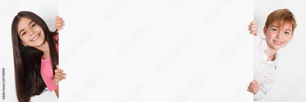 Children looking out of blank advertising board, copy space Children looking out of blank advertising board, copy space