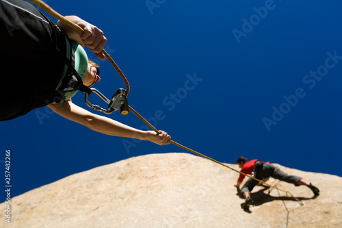 Sarah Felchlin (left) belaying Mitch Underhill while rock climbing at Owens River Gorge near Bishop, California. photo