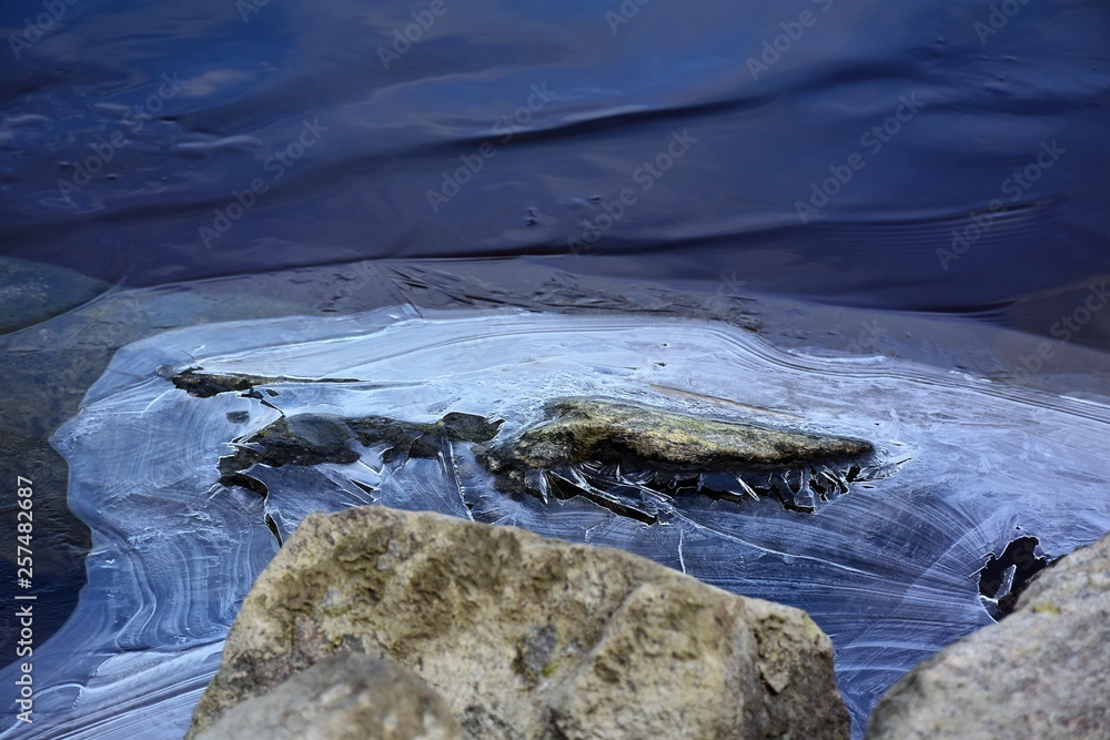 a piece of ice on the river bank in spring