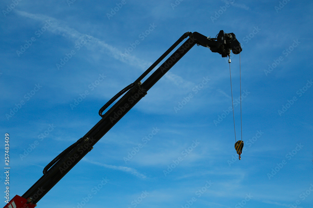 Abstract Industrial background with construction tower crane silhouette over blue sky . Abstract Industrial background with construction tower crane silhouette over blue sky .