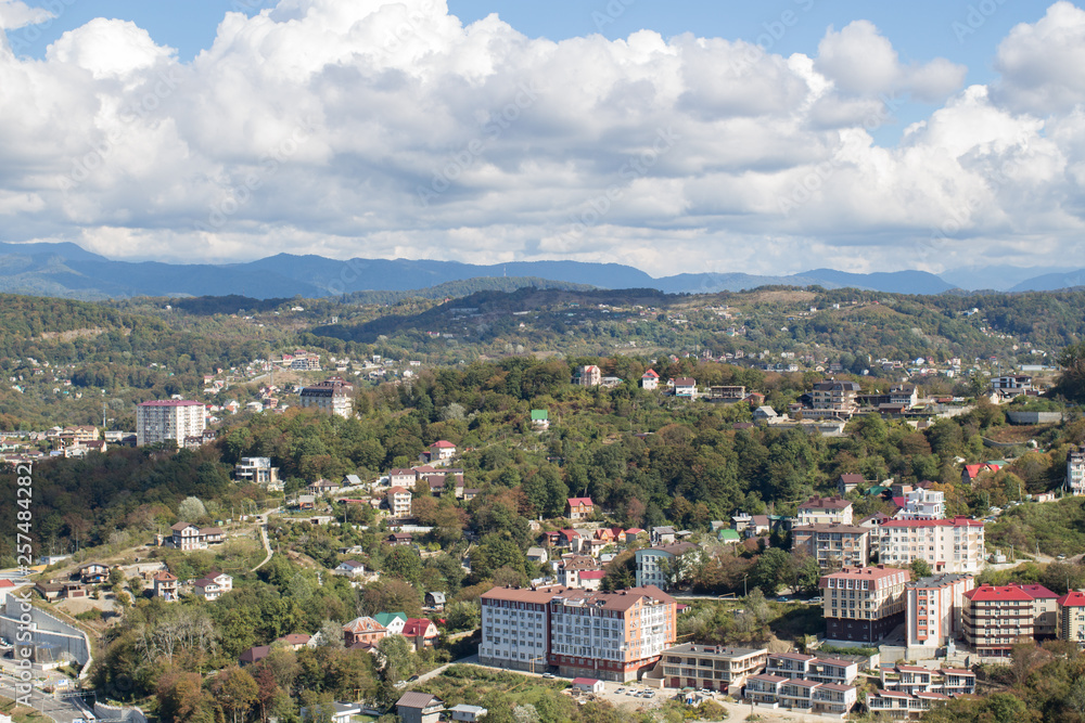 Panorama of the city by the mountains in summer