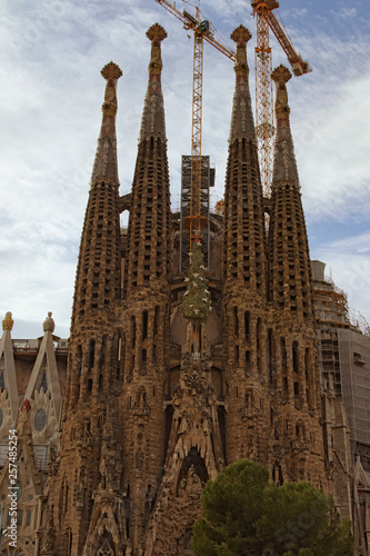Barcelona, Spain-January 02, 2016: Amazing Church of the Holy Family surrounded by cranes. It is a large unfinished Roman Catholic church in Barcelona, designed by Catalan architect Antoni Gaudi