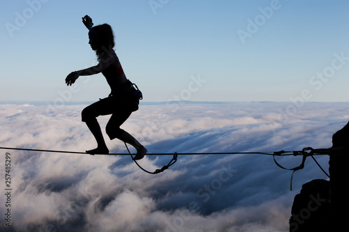 Silhouette of professional highliner Hayley Ashburn standing up on a highline above the clouds atop Mount Tamalpais  photo