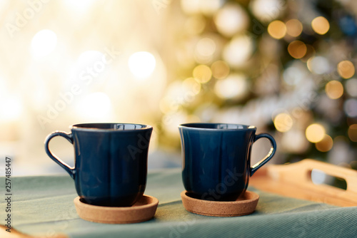 cups with tea on the background of the Christmas tree