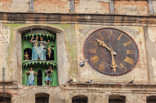 Part of the facade of the clock tower in Sighisoara, Romania photo