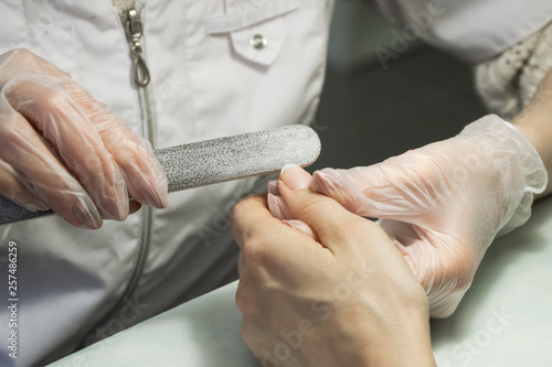 Treatment of nails with a nail file.