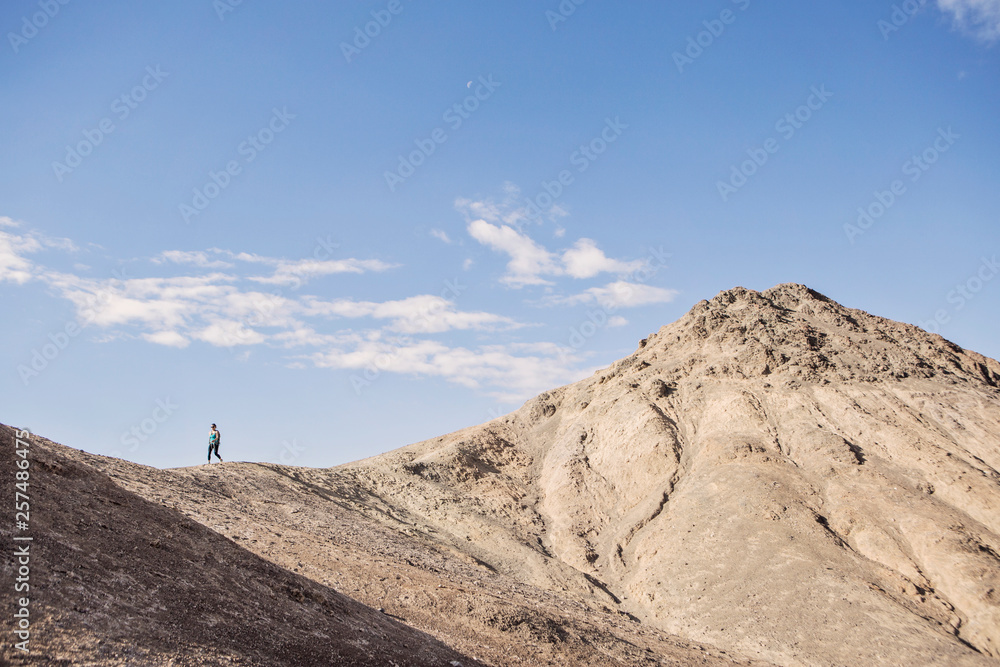 A hiker descends a peak on the Desolation Canyon Trail, Death Valley National Park, California. A hiker descends a peak on the Desolation Canyon Trail, Death Valley National Park, California.