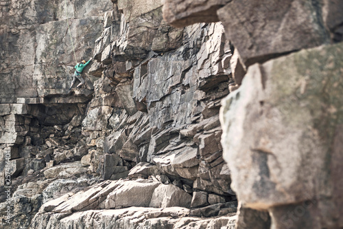 Rock climber climbing Otter Cliffs, Acadia National Park, Maine, USA photo