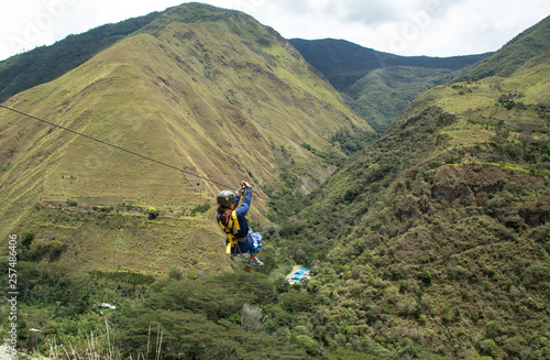 Woman riding on zipline through Amazon forest, Santa Teresa, Cusco region, Peru photo