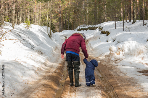Father and son walk on the forest road