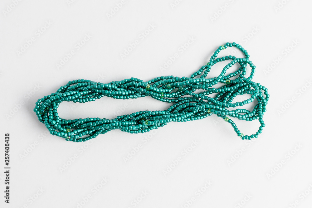 Teal green sand beards displayed as a flower isolated on white background, flat lay, top view, 