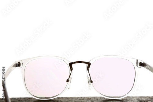 Glasses on wooden table against white background. Ophthalmologist consultation