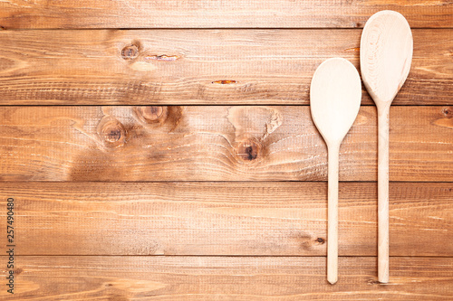 Wooden kitchen spoons on brown table