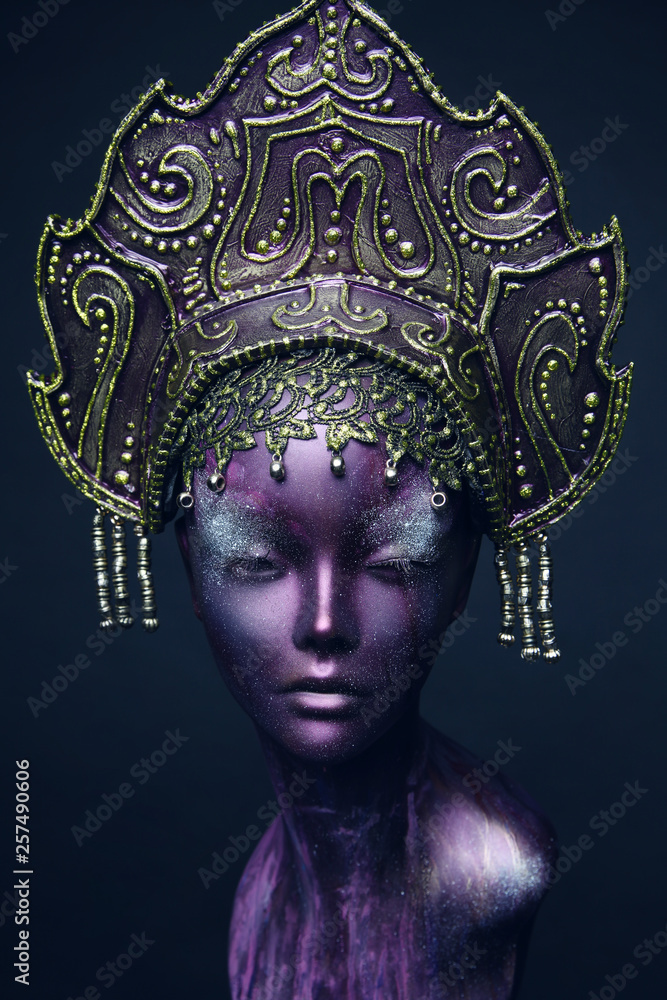 Head of mannequin in decorated bronze kokoshnick, dark studio background Head of mannequin in decorated bronze kokoshnick, dark studio background