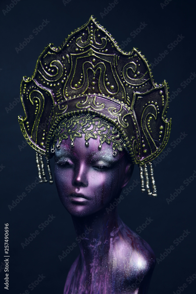 Head of mannequin in decorated bronze kokoshnick, dark studio background