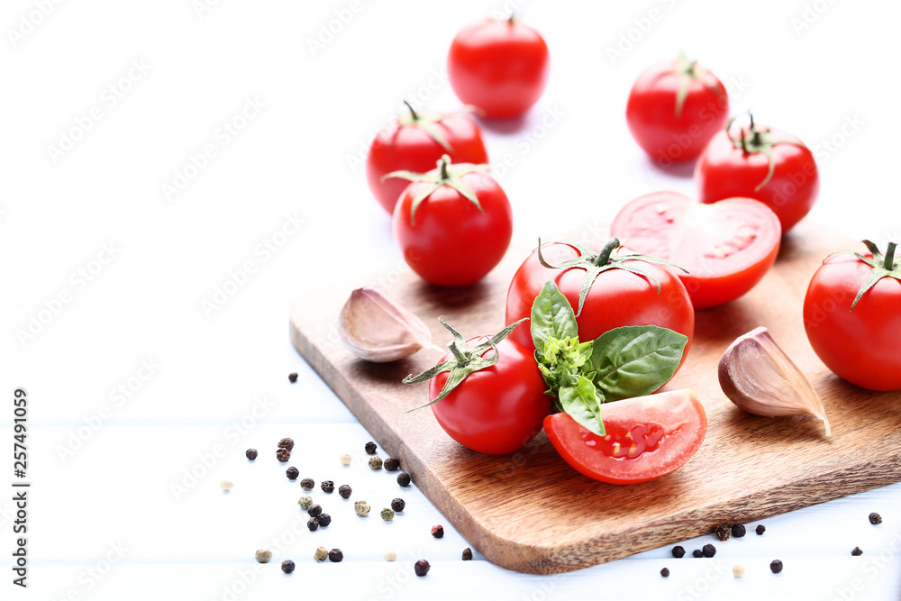 Ripe tomatoes with basil leafs and garlic on wooden table Ripe tomatoes with basil leafs and garlic on wooden table