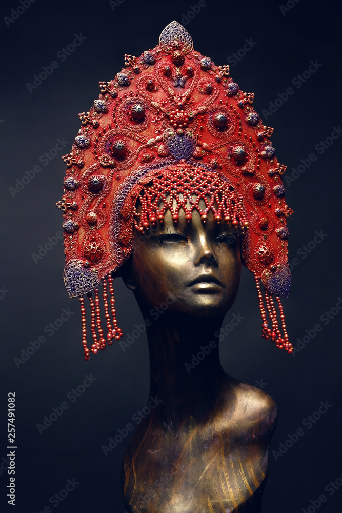 Head of woman mannequin in red decorated kokoshnick, black studio background Head of woman mannequin in red decorated kokoshnick, black studio background