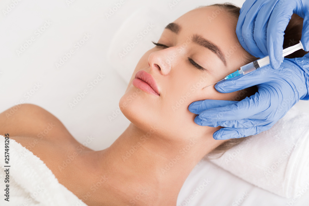 Beauty procedure. Woman receiving hyaluronic acid injection
