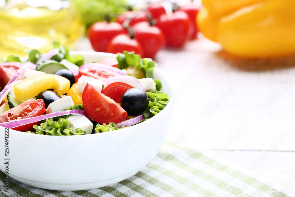 Vegetable salad in bowl with napkin on wooden table Vegetable salad in bowl with napkin on wooden table