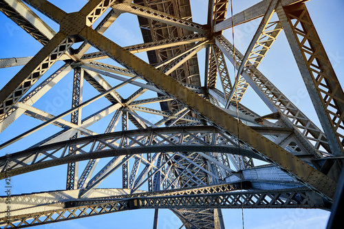 View of the historic city of Porto, Portugal with the Dom Luiz bridge. A metro train can be seen on the bridge