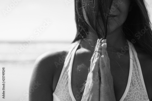 Close up of woman doing yoga on beach, black and white
