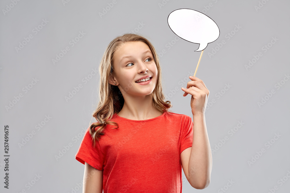 communication and people concept - smiling teenage girl with long hair in red t-shirt holding blank speech bubble over grey background communication and people concept - smiling teenage girl with long hair in red t-shirt holding blank speech bubble over grey background