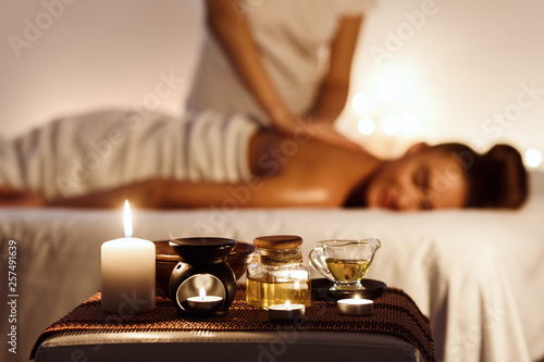 Relaxed woman enjoying aromatherapy massage in luxury spa photo