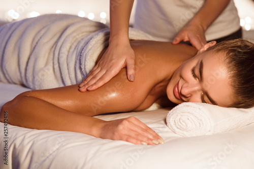 Woman enjoying shoulder massage in the health spa