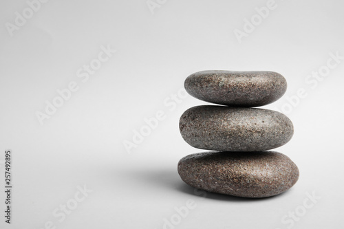 Stacked zen stones on white background. Space for text