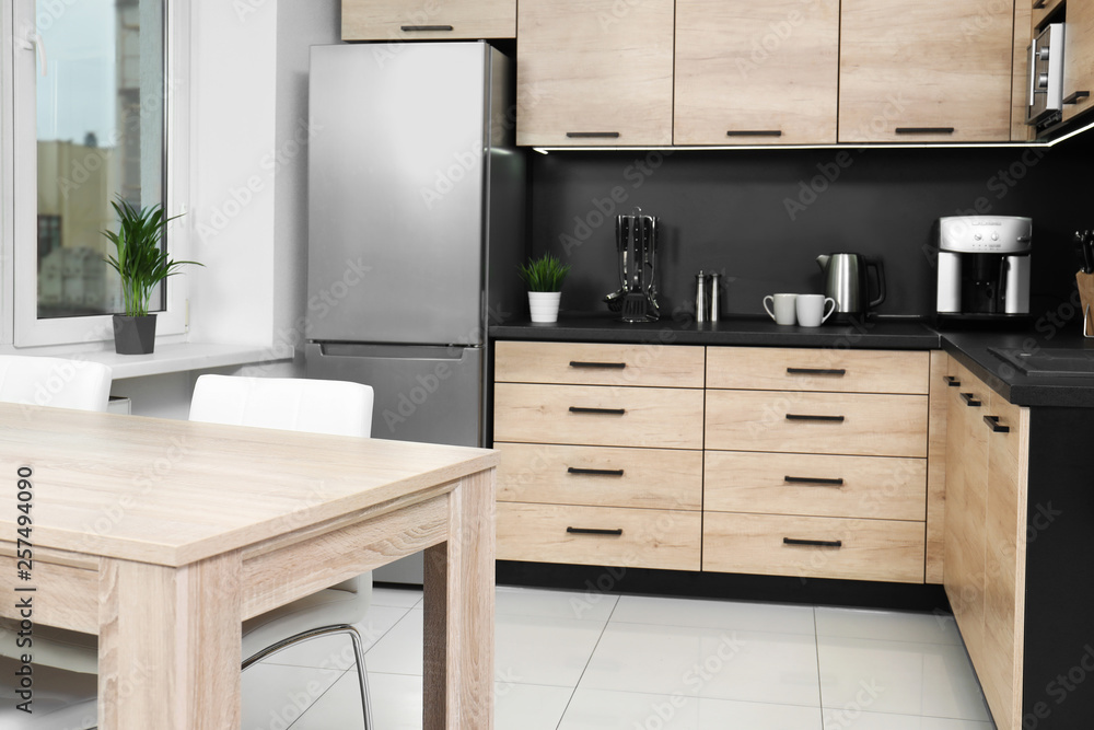 Cozy modern kitchen interior with new furniture and appliances Cozy modern kitchen interior with new furniture and appliances