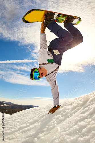 Snowboarder doing handplant trick, Vermont, USA photo