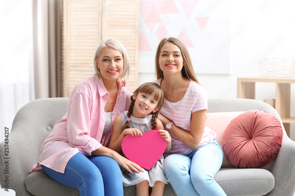 Beautiful mature lady, daughter and grandchild with gift box at home. Happy Women's Day Beautiful mature lady, daughter and grandchild with gift box at home. Happy Women's Day