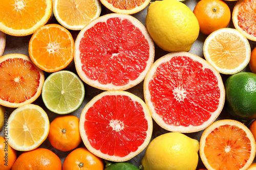 Different citrus fruits as background  top view