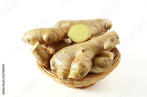 Fresh ginger root spice with slice isolated on white background