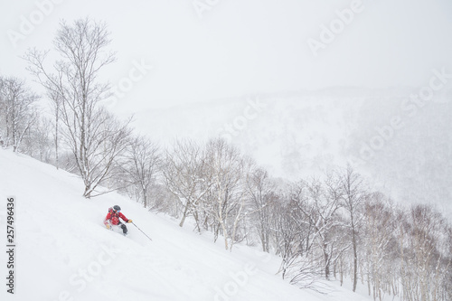 Telemark skiing in powder near Niseko United resorts in Hokkaido.