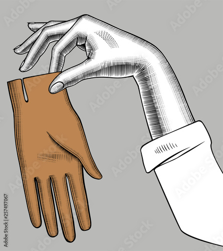 Female hand holding a brown glove