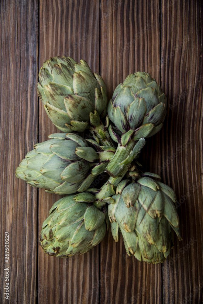 Fototapeta premium artichokes on old wooden table
