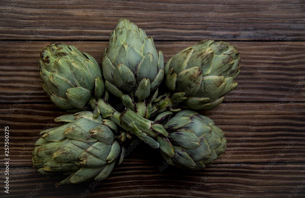 artichokes on old wooden table artichokes on old wooden table