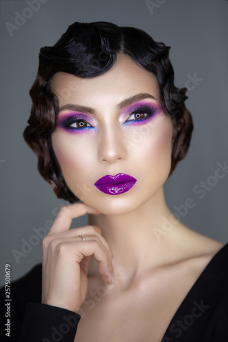 portrait of a romantic mysterious girl with a marcel wave hairstyle and bright rich makeup of the 1920s