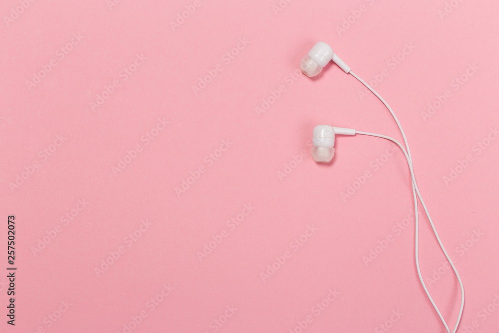 Obraz premium Headphones on pastel background. White headphones on a pink background.