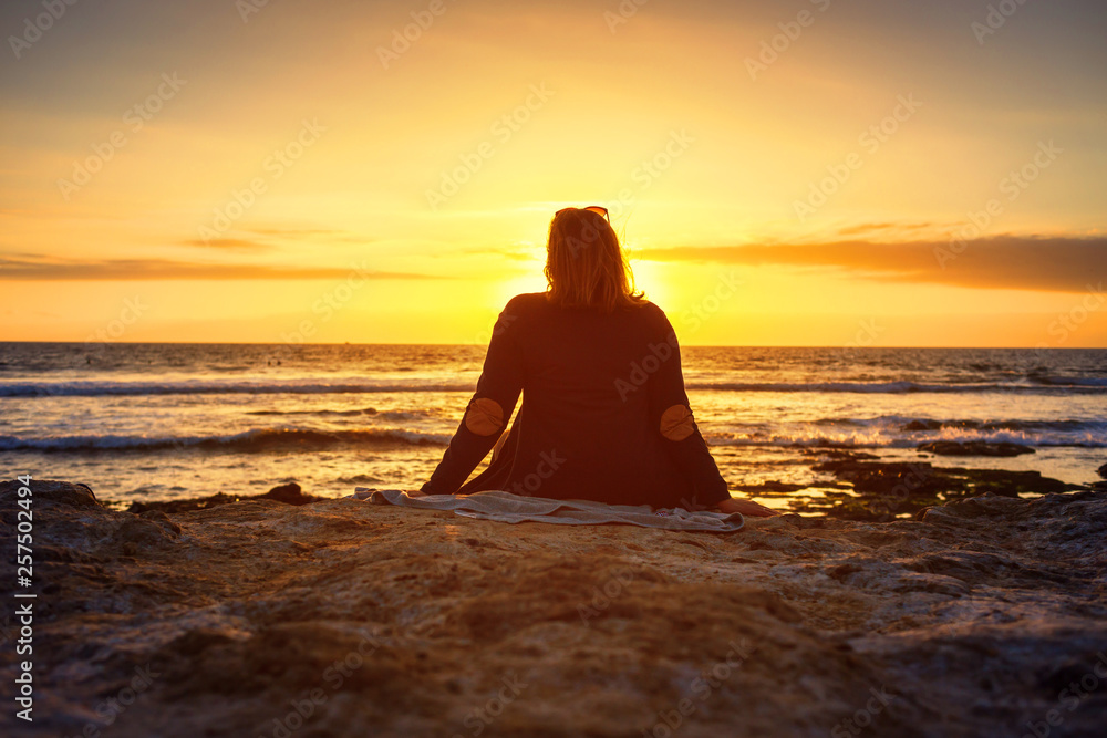 girl looks at the Sunset on Atlantic Ocean in Tenerife Canary Island Spain girl looks at the Sunset on Atlantic Ocean in Tenerife Canary Island Spain