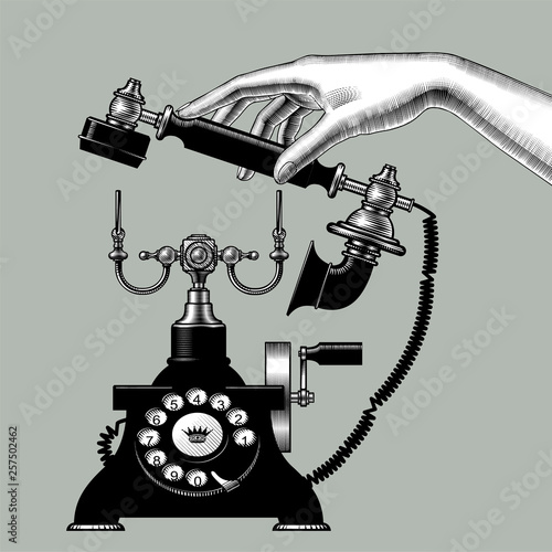 Female hand of man with retro black phone