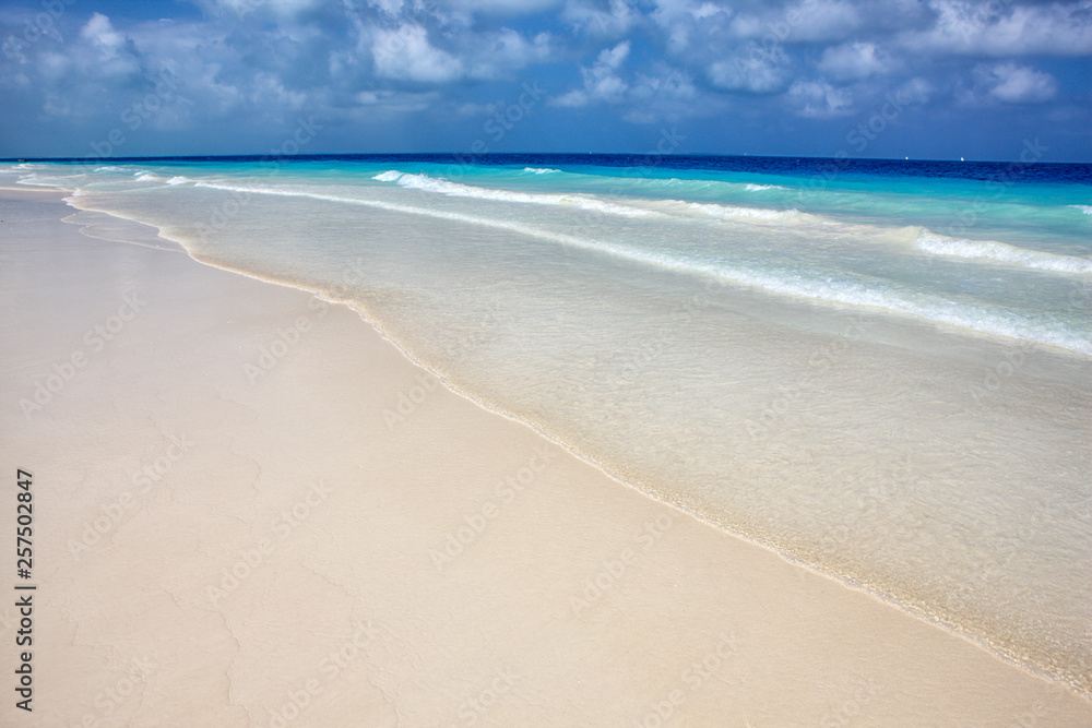 Deserted beach in Nungwi with the blue waters of the Indian Ocean on the background, Nungwi, Zanzibar, Tanzania, East Africa. Deserted beach in Nungwi with the blue waters of the Indian Ocean on the background, Nungwi, Zanzibar, Tanzania, East Africa.